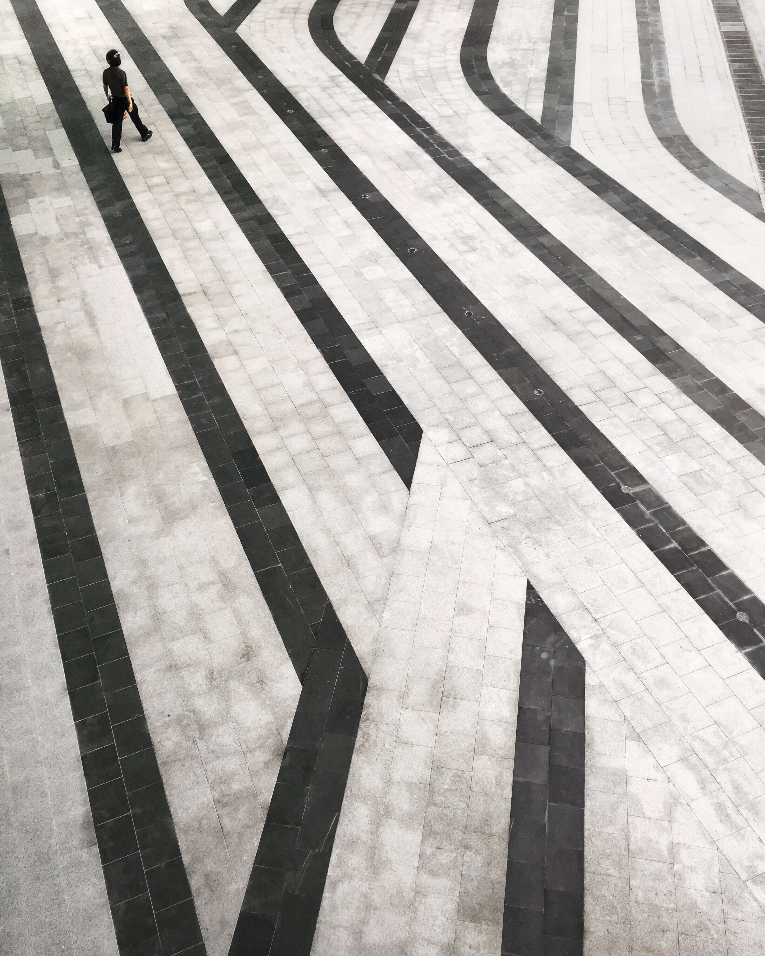 person walking across tiled floor