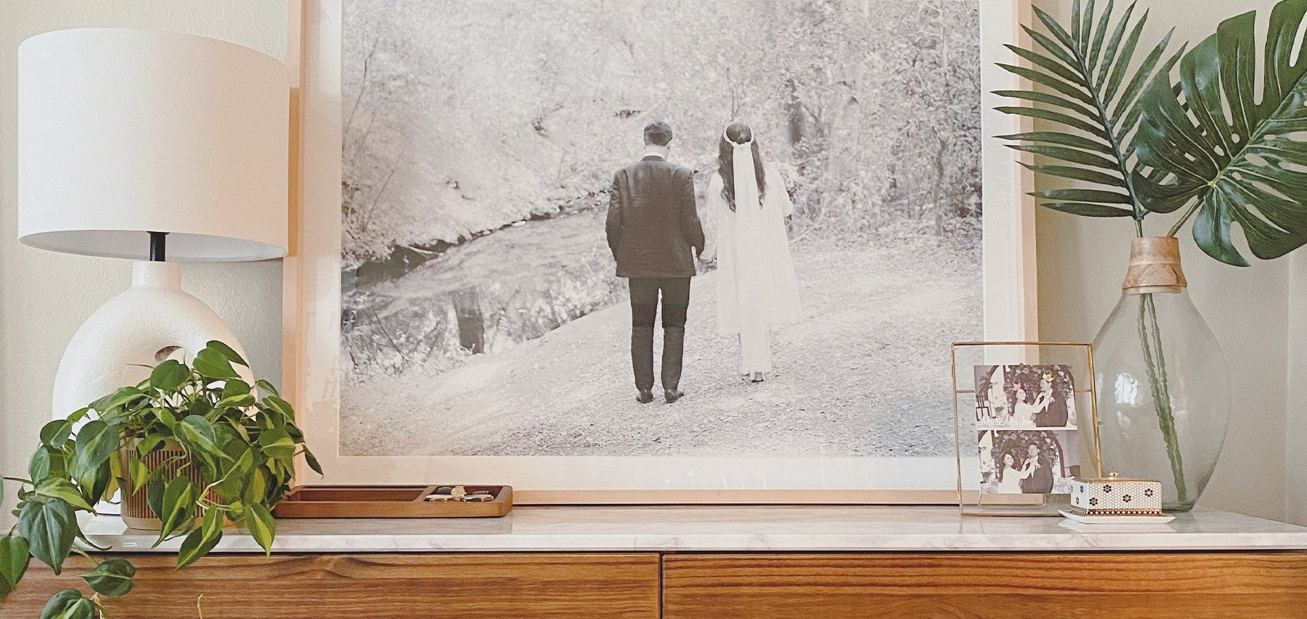 Large Artifact Uprising Gallery Frame with wedding photo atop mantle filled with plants and decor