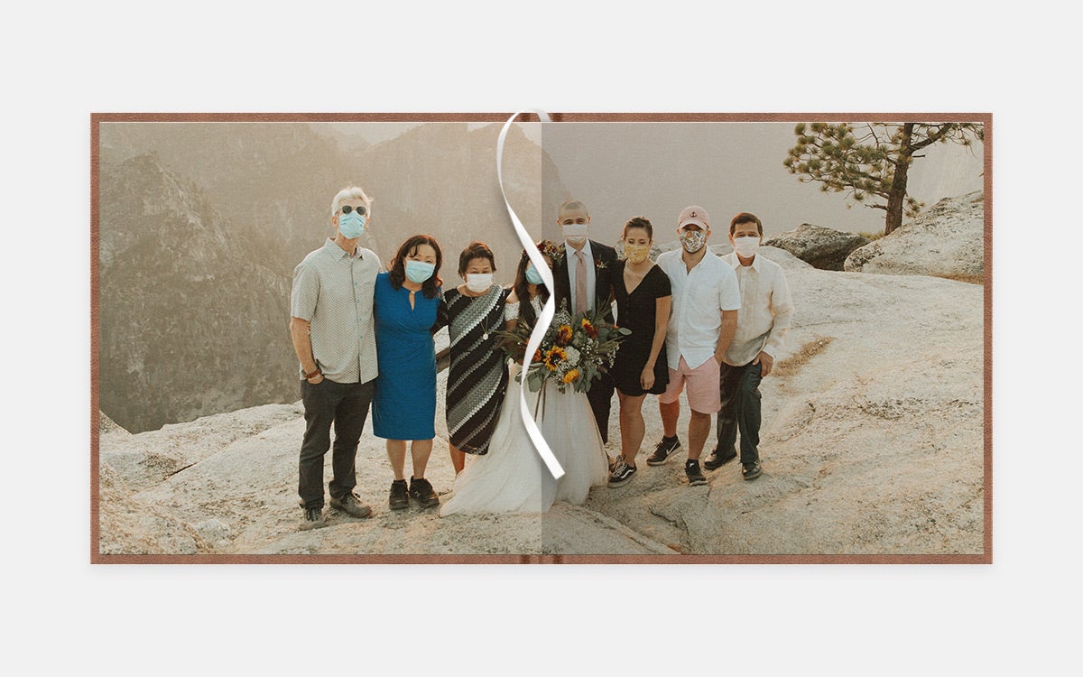 Two page panoramic image of bride, groom, and family at cliffside setting wearing masks