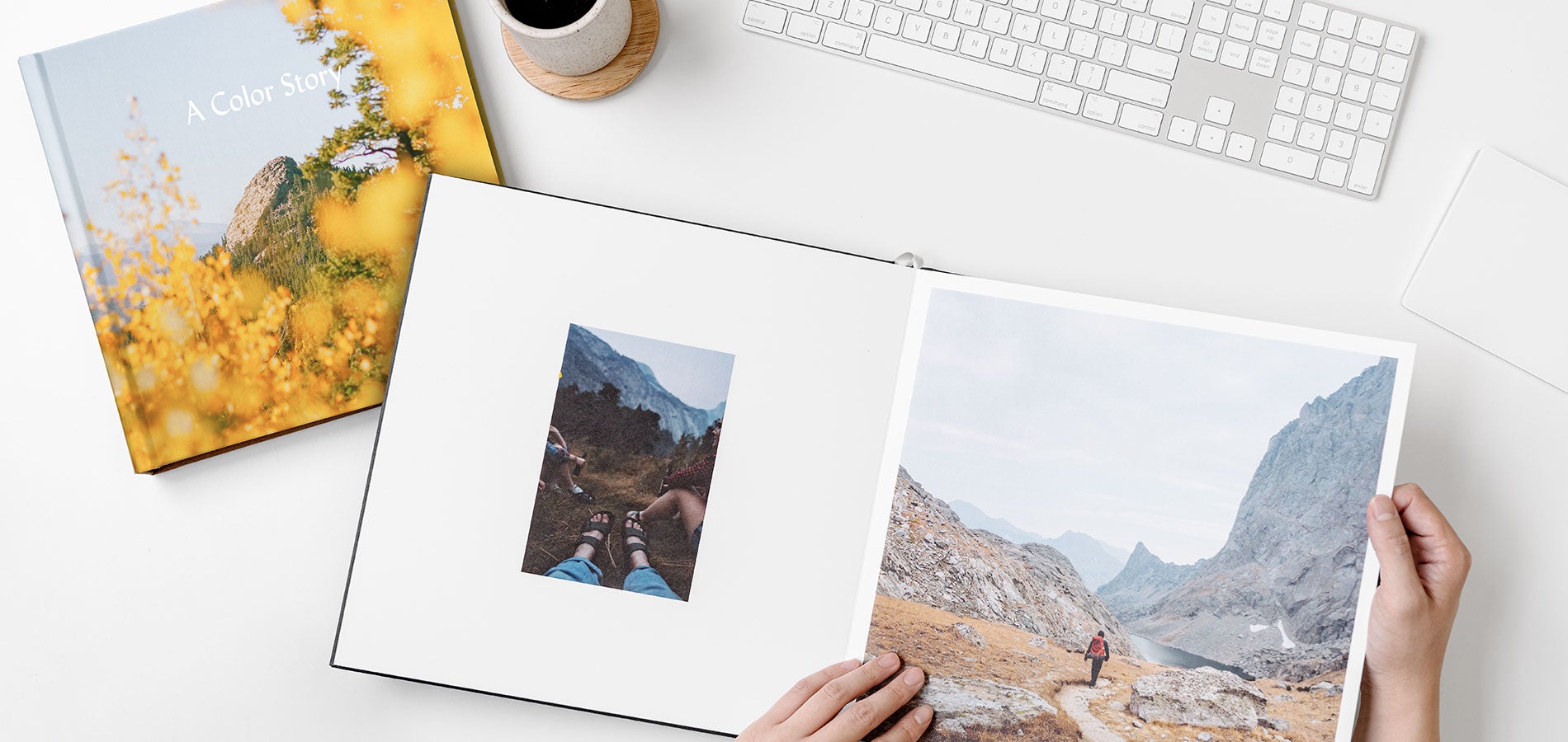 Artifact Uprising photo book and cup of coffee next to keyboard