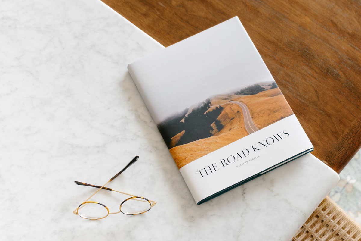 travel photo book with winding road on book cover