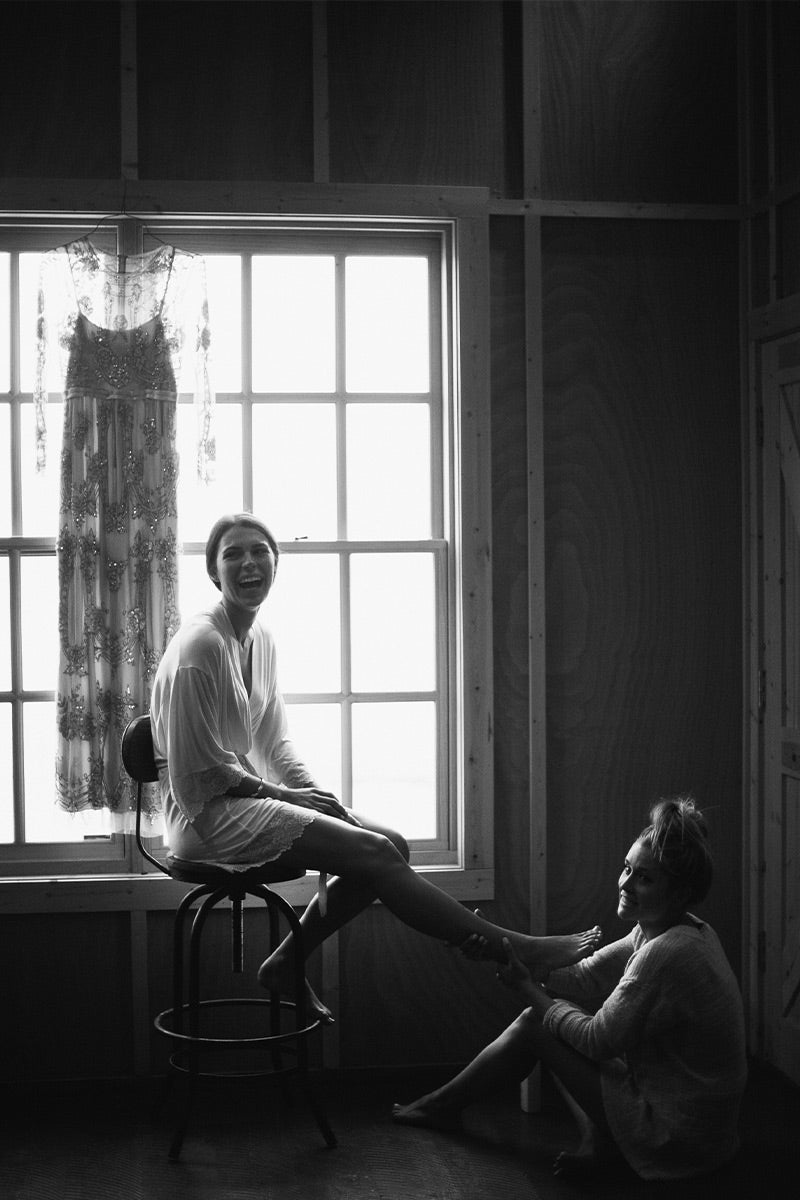 Bride getting ready with bridesmaid