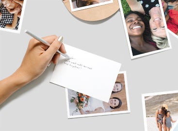 Woman's hand writing a note on the back of a photo print