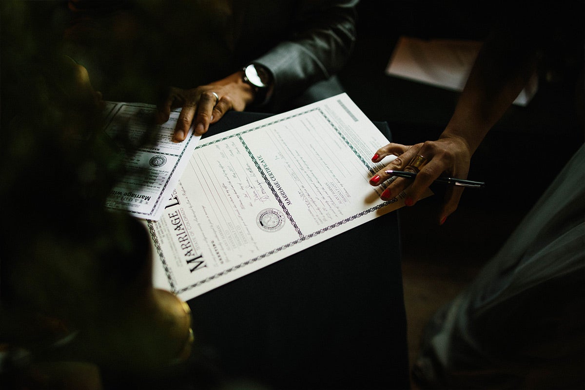 Couple signing marriage license