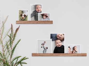 Baby photos on wooden picture ledge