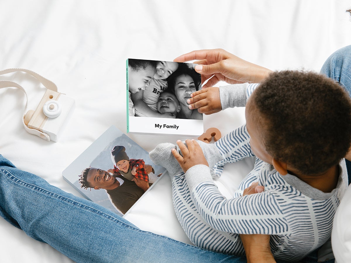 Baby picking up board book titled My Family