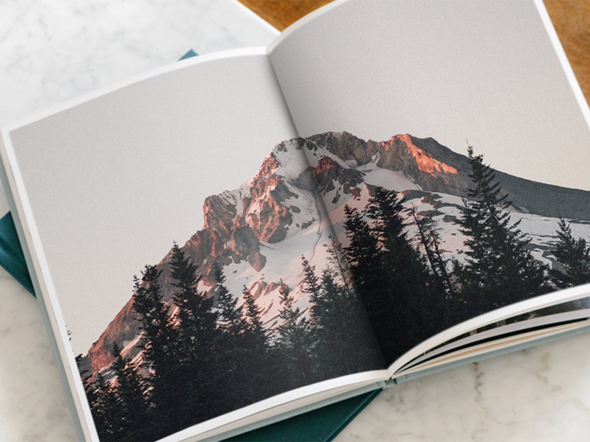 Hardcover Photo Book opened to picture of mountainscape