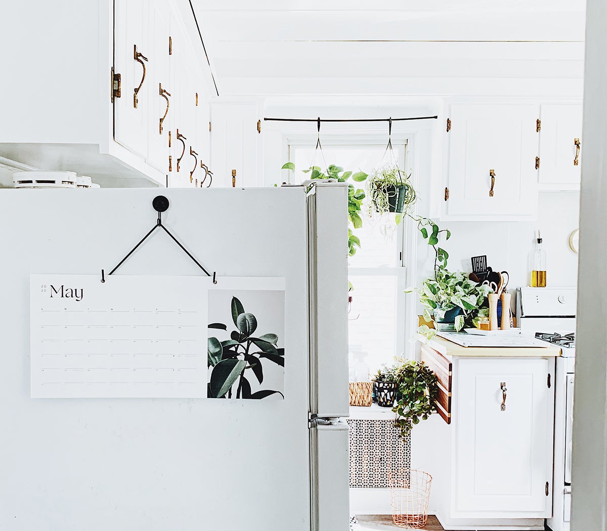 Photo by @kellybananatree of Artifact Uprising Modern Wall Calendar hanging in brightly-lit kitchen