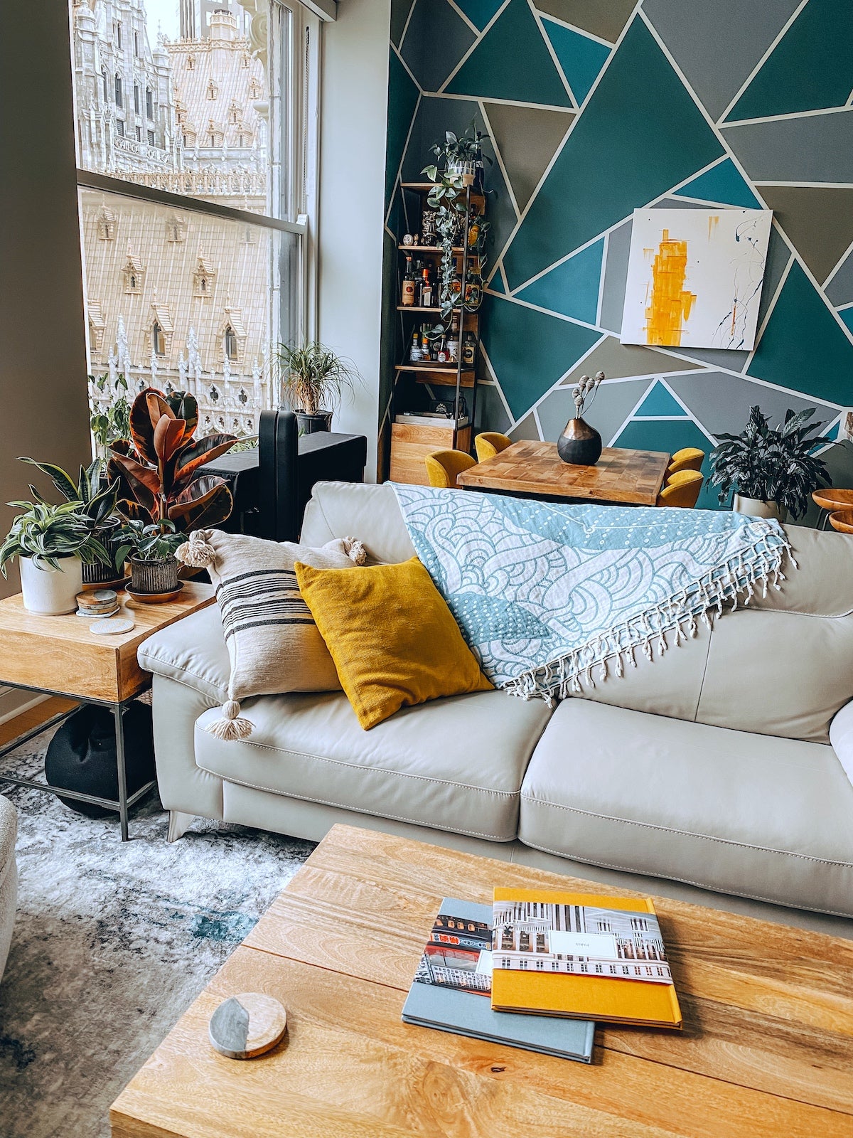 An Artifact Uprising Hardcover Photo Books on coffee table in artsy apartment with honeycomb decor accents