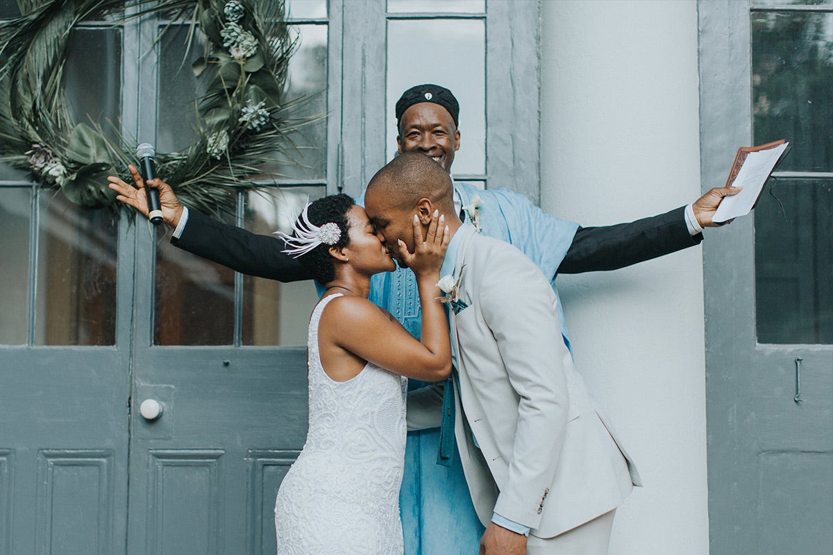 Bride and groom sharing first kiss as husband and wife