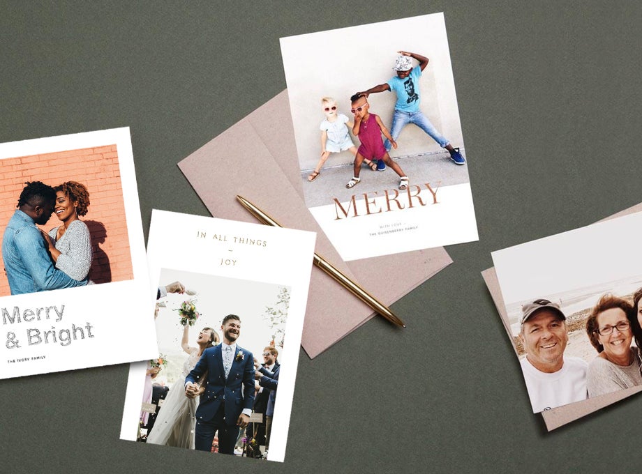 Holiday cards laid out on table with pen