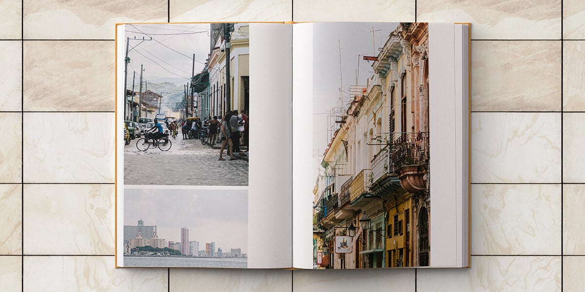 Cuba photo album opened to two-pages of cityscape images