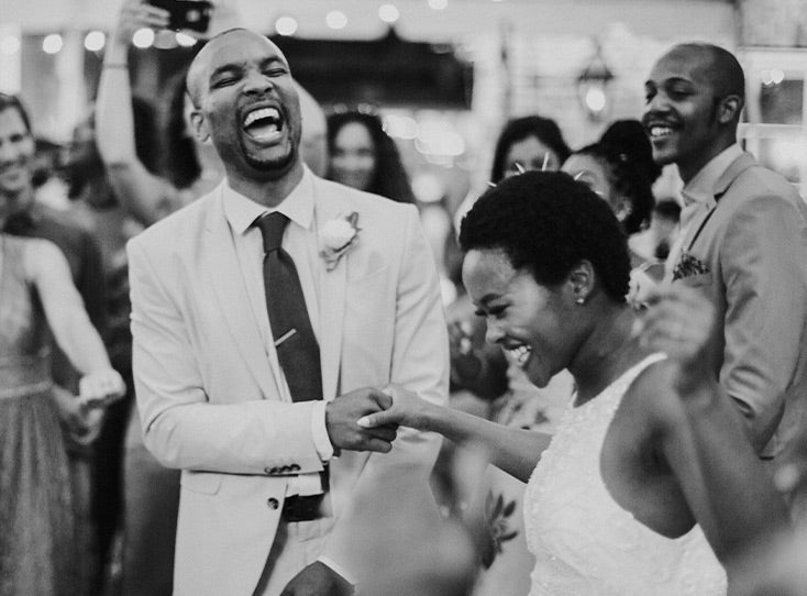 Jubilant bride and groom making their entrance onto the dance floor