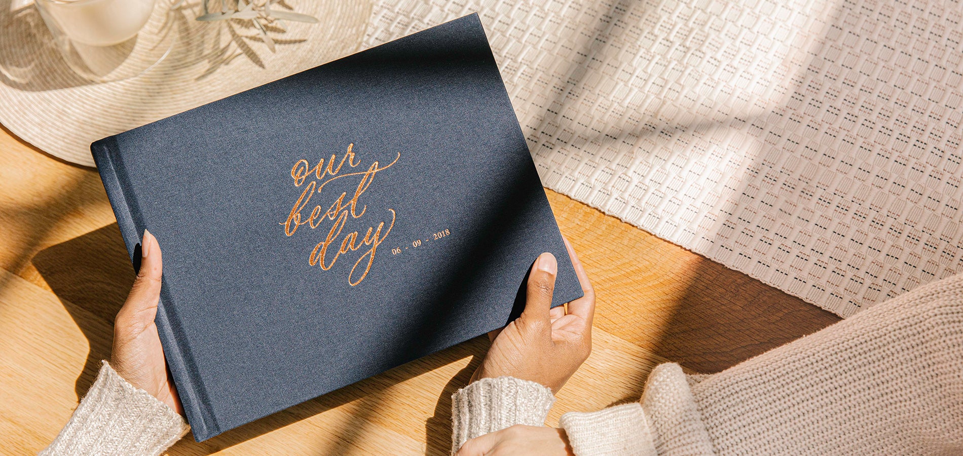 Woman's hands holding Midnight Blue Artifact Uprising Wedding Photo Album